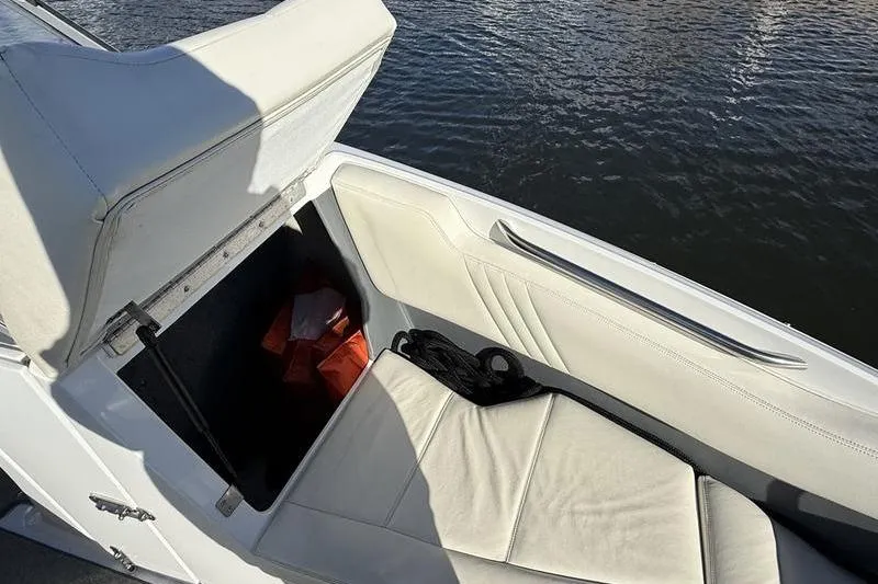 Slide: The Image of Open storage compartment on 2008 Cobalt 202 boat with life jackets and rope. - 16