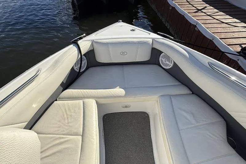 Slide: The Image of 2008 Cobalt 202 boat interior with white cushioned seating and gray carpet. - 17