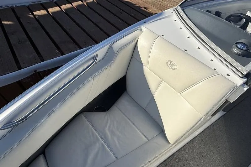 Slide: The Image of 2008 Cobalt 202 boat interior with white leather seating and dashboard view. - 19