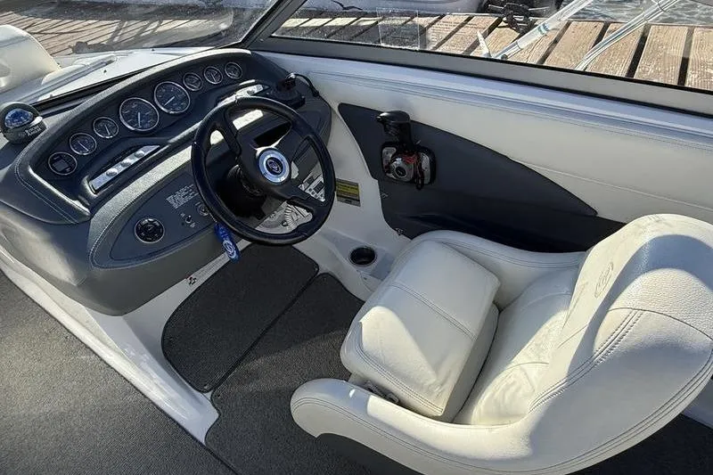 Slide: The Image of Interior of a 2008 Cobalt 202 boat showing steering wheel and dashboard controls. - 26