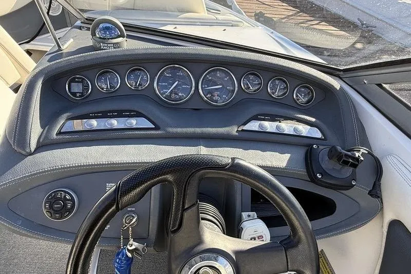 Slide: The Image of Dashboard of a 2008 Cobalt 202 boat with gauges and steering wheel. - 28