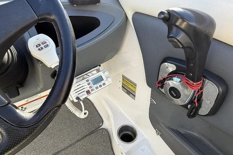 Slide: The Image of 2008 Cobalt 202 boat cockpit with steering wheel, throttle, and radio controls. - 29