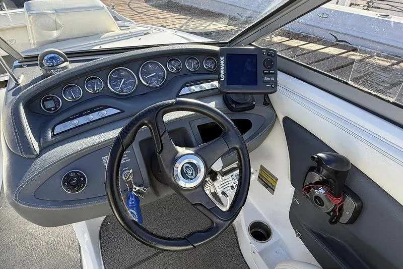 Slide: The Image of Dashboard of a 2008 Cobalt 202 boat with steering wheel and navigation instruments. - 31