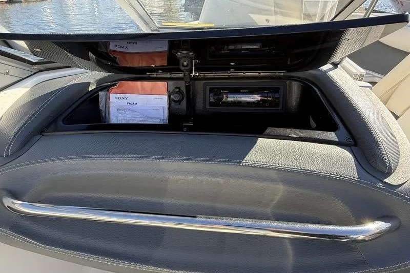 Slide: The Image of 2008 Cobalt 202 boat dashboard with Sony stereo system and storage compartment. - 33