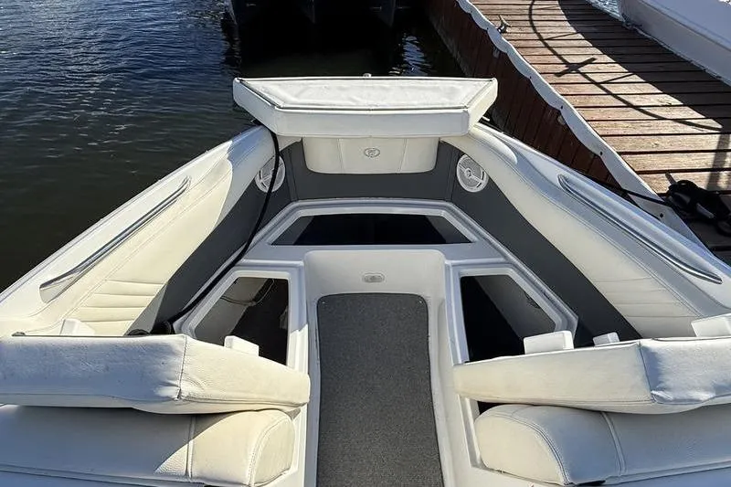 Slide: The Image of 2008 Cobalt 202 boat interior with white seating and gray accents, docked by wooden pier. - 35