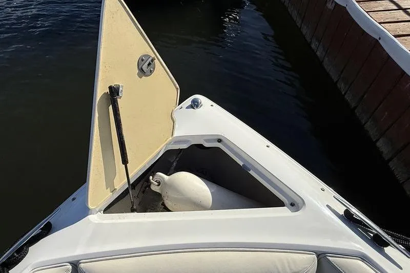 Slide: The Image of Open storage compartment on 2008 Cobalt 202 boat, revealing a white fender inside. - 37