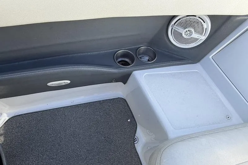 Slide: The Image of Interior of a 2008 Cobalt 202 boat with cup holders and speaker. - 39