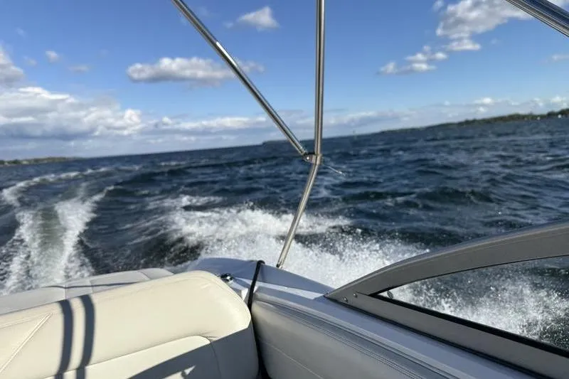 Slide: The Image of 2008 Cobalt 202 boat cruising on a sunny day with waves and blue sky. - 44