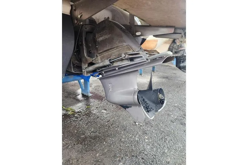 Slide: The Image of 2008 Cobalt 202 boat outdrive on a wet surface, showcasing propeller and lower unit. - 47