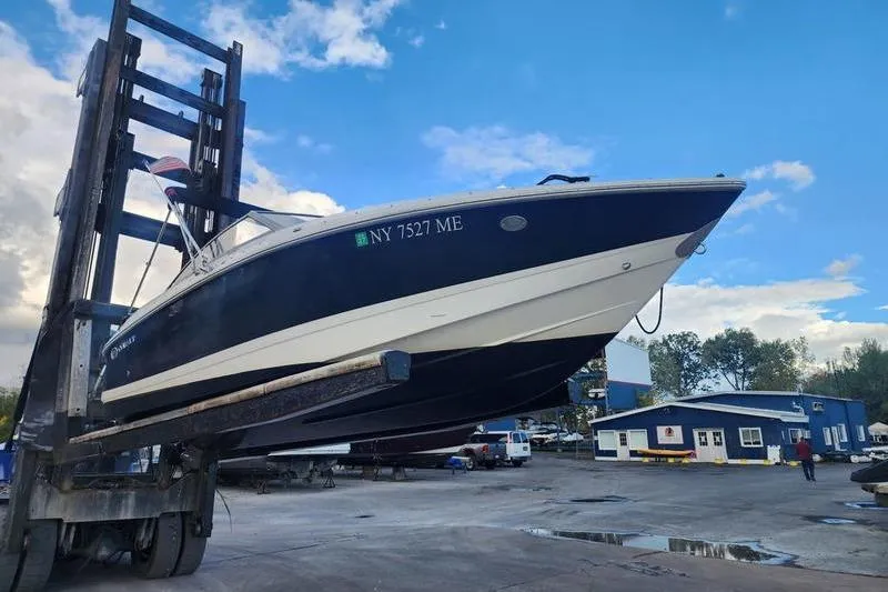 Slide: The Image of 2008 Cobalt 202 boat lifted by forklift in marina setting. - 5
