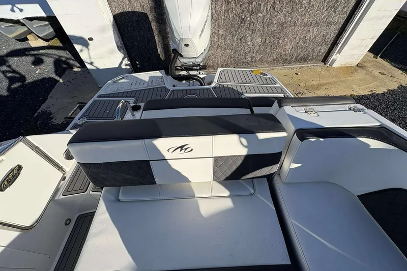 Slide: The Image of 2020 Monterey M-65 boat interior with cushioned seating and sleek design. - 12