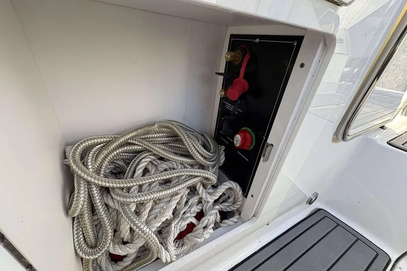 Slide: The Image of Storage compartment in 2020 Monterey M-65 boat with coiled rope and control panel. - 14