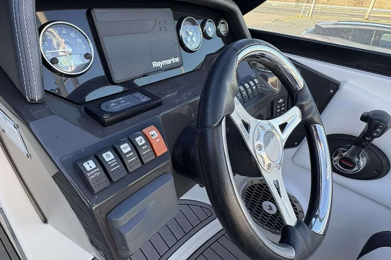 Slide: The Image of Cockpit of 2020 Monterey M-65 boat with steering wheel and control panel. - 19