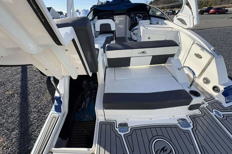 Slide: The Image of 2020 Monterey M-65 boat interior with seating and steering area, featuring modern design elements. - 23