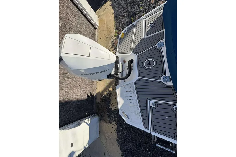 Slide: The Image of 2020 Monterey M-65 boat with Mercury outboard engine, featuring a sleek deck design. - 8