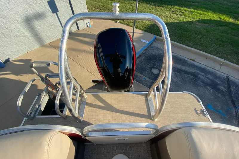 Slide: The Image of 2018 Hampton 2485 SE boat with motor and ladder, parked on pavement. - 15