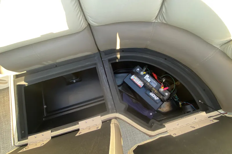 Slide: The Image of 2018 Hampton 2485 SE boat storage compartment with battery setup. - 19