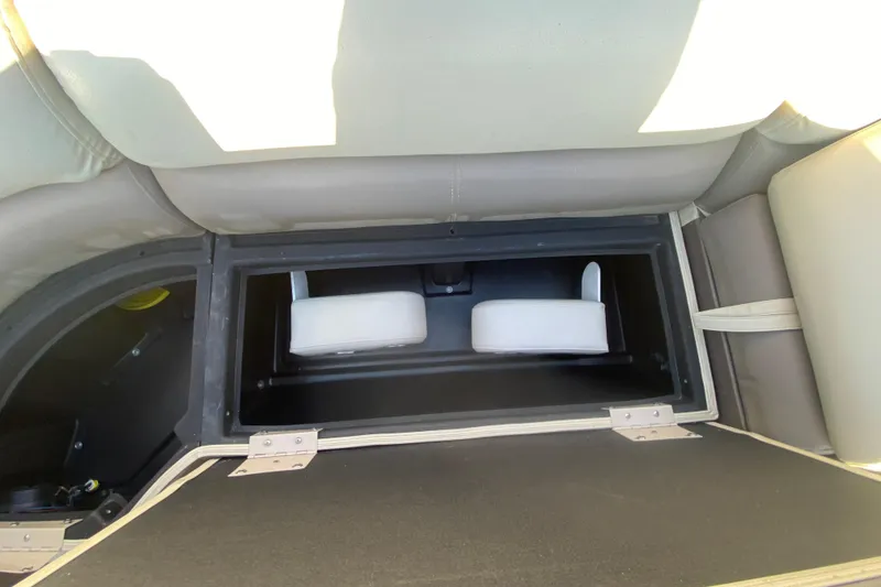 Slide: The Image of 2018 Hampton 2485 SE boat storage compartment with cushioned seating. - 21