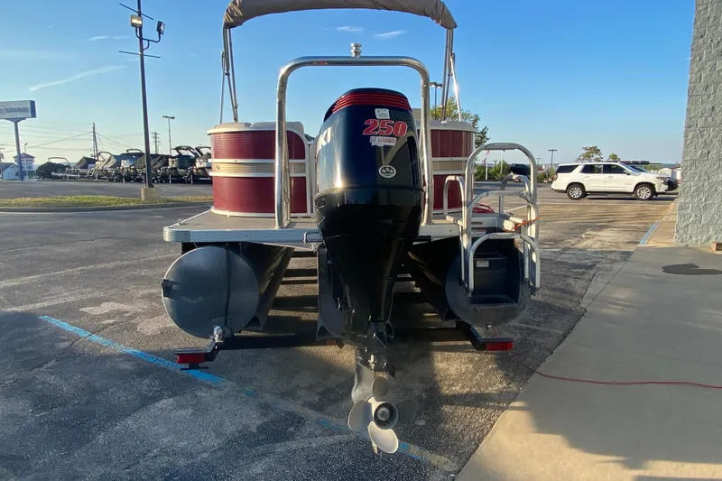 Slide: The Image of 2018 Hampton 2485 SE pontoon boat with Suzuki 250 outboard motor in a parking lot. - 30