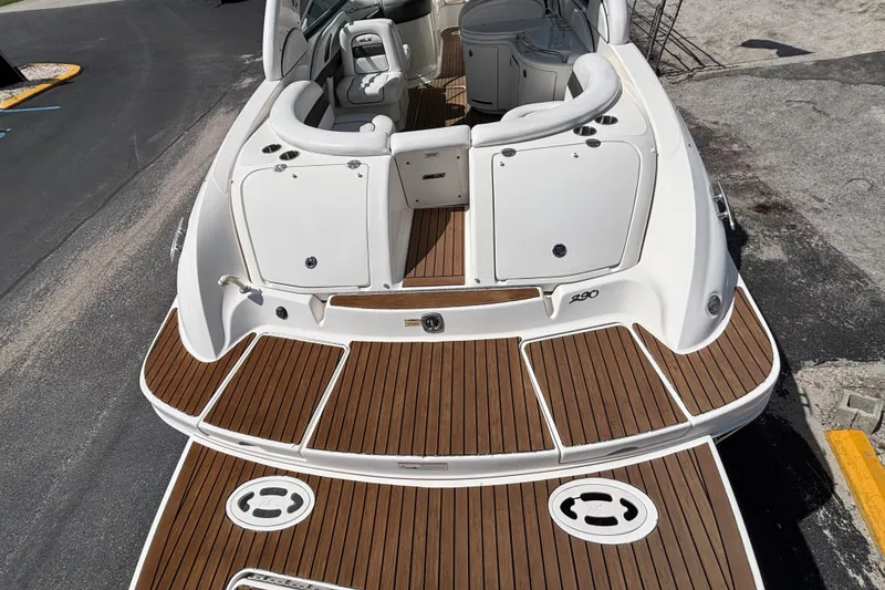Slide: The Image of 2006 Sea Ray 290 SLX boat with teak deck and white seating. - 11