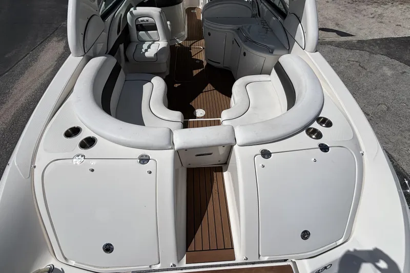 Slide: The Image of 2006 Sea Ray 290 SLX boat interior with white seating and wood flooring. - 13