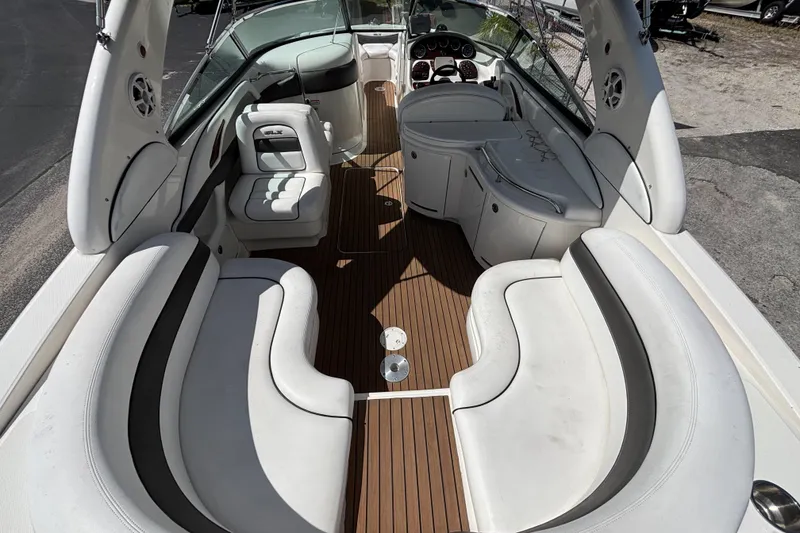Slide: The Image of 2006 Sea Ray 290 SLX boat interior with white seating and wood flooring. - 15