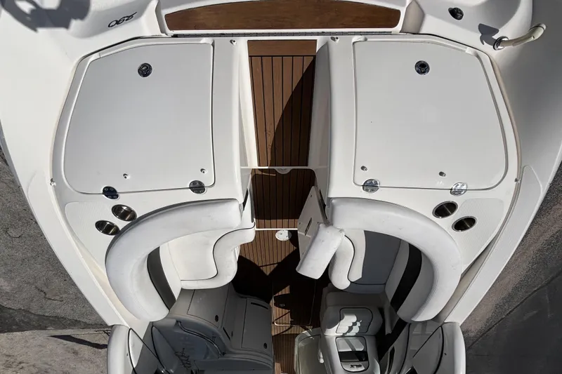 Slide: The Image of 2006 Sea Ray 290 SLX boat interior with white seating and wooden flooring. - 16