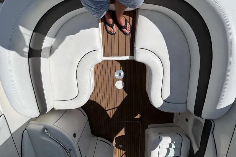 Slide: The Image of Overhead view of 2006 Sea Ray 290 SLX boat interior with white seating and wooden deck. - 17