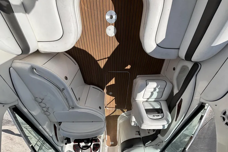 Slide: The Image of Interior of 2006 Sea Ray 290 SLX boat with white seating and wooden flooring. - 18