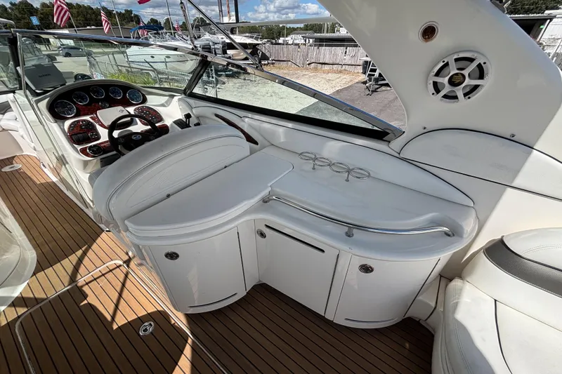 Slide: The Image of 2006 Sea Ray 290 SLX boat interior with helm, seating, and wood flooring. - 19