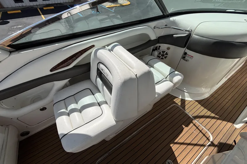Slide: The Image of 2006 Sea Ray 290 SLX boat interior with white seating and wood flooring. - 20