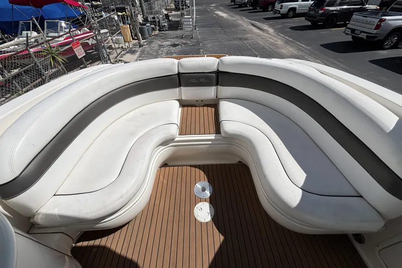 Slide: The Image of 2006 Sea Ray 290 SLX boat with white leather seating and wooden deck. - 21