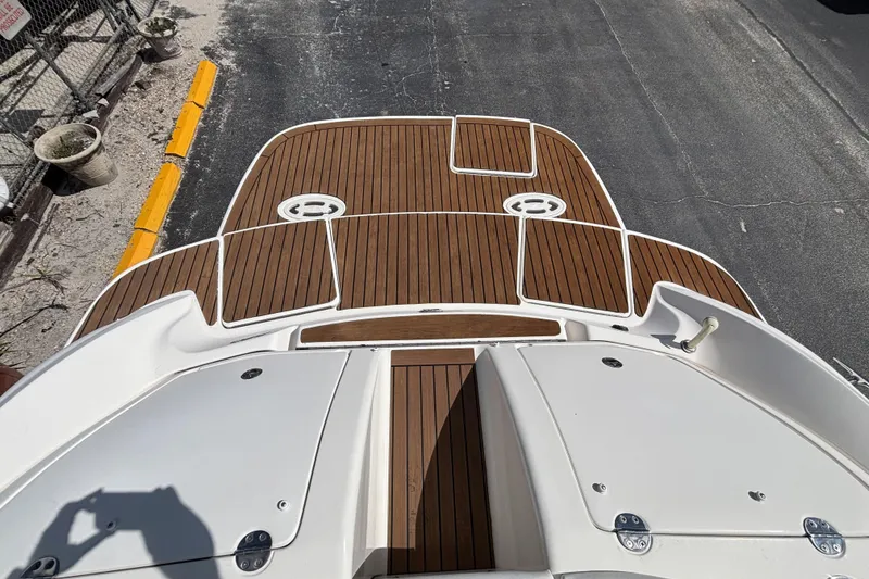 Slide: The Image of 2006 Sea Ray 290 SLX boat deck with wood finish and white accents. - 22