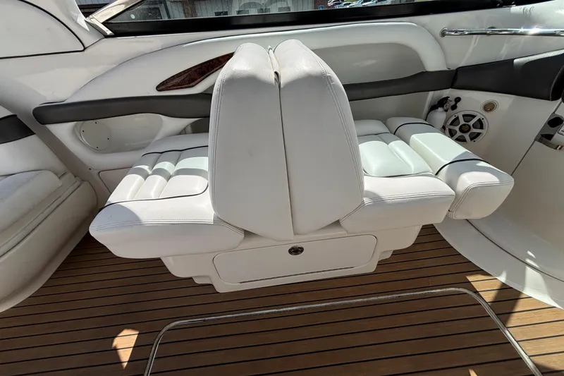 Slide: The Image of 2006 Sea Ray 290 SLX interior with white seating and teak flooring. - 26