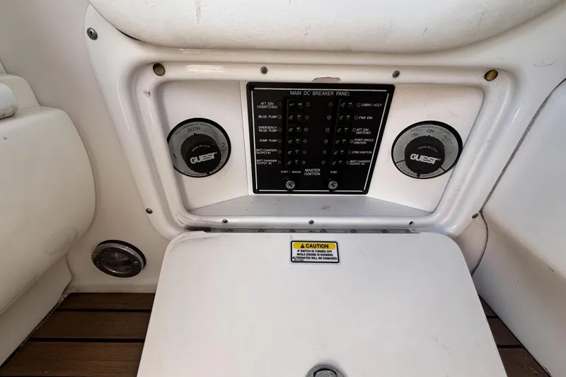 Slide: The Image of 2006 Sea Ray 290 SLX main DC breaker panel with Guest battery switches. - 28