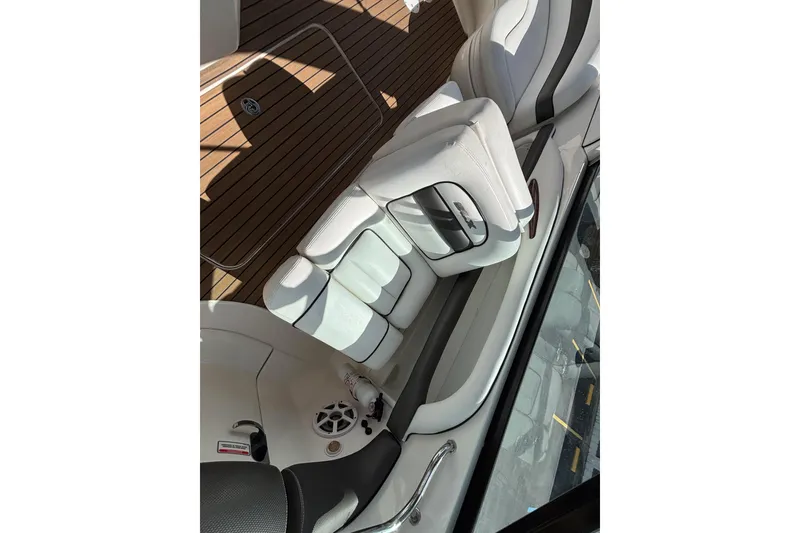 Slide: The Image of Luxurious interior of 2006 Sea Ray 290 SLX boat with white seating and wood flooring. - 29