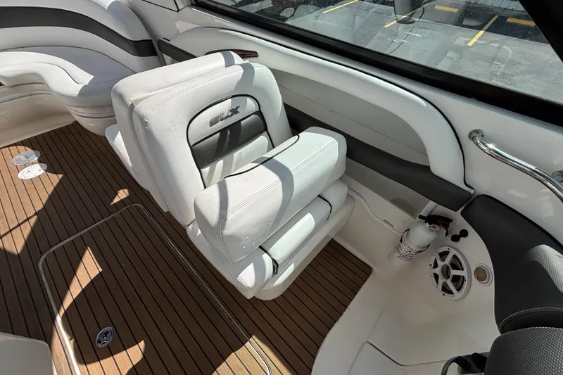 Slide: The Image of Interior of 2006 Sea Ray 290 SLX boat with white seating and wood flooring. - 30