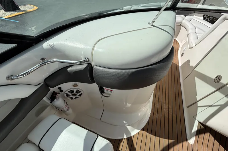 Slide: The Image of 2006 Sea Ray 290 SLX boat interior with white seating and wood flooring. - 31