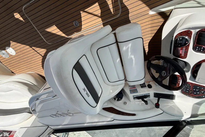 Slide: The Image of 2006 Sea Ray 290 SLX boat interior with white seating and wood accents. - 35