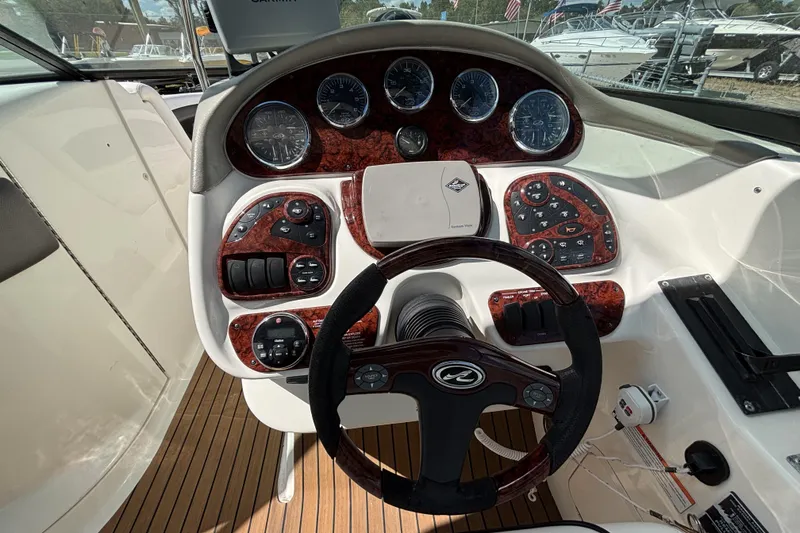Slide: The Image of 2006 Sea Ray 290 SLX boat dashboard with steering wheel and control panels. - 37