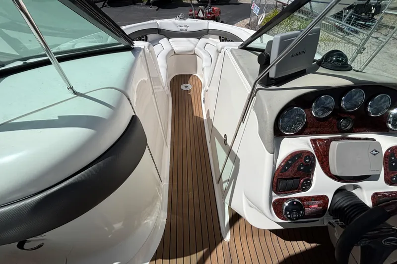 Slide: The Image of 2006 Sea Ray 290 SLX boat interior with wood flooring and control panel. - 40