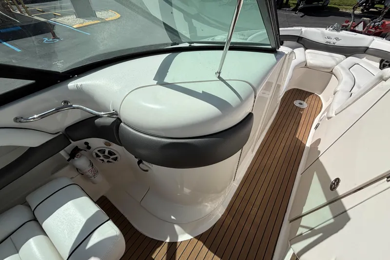Slide: The Image of 2006 Sea Ray 290 SLX boat interior with white seating and wood flooring. - 41