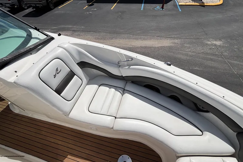 Slide: The Image of 2006 Sea Ray 290 SLX boat with white leather seating and wooden deck. - 43