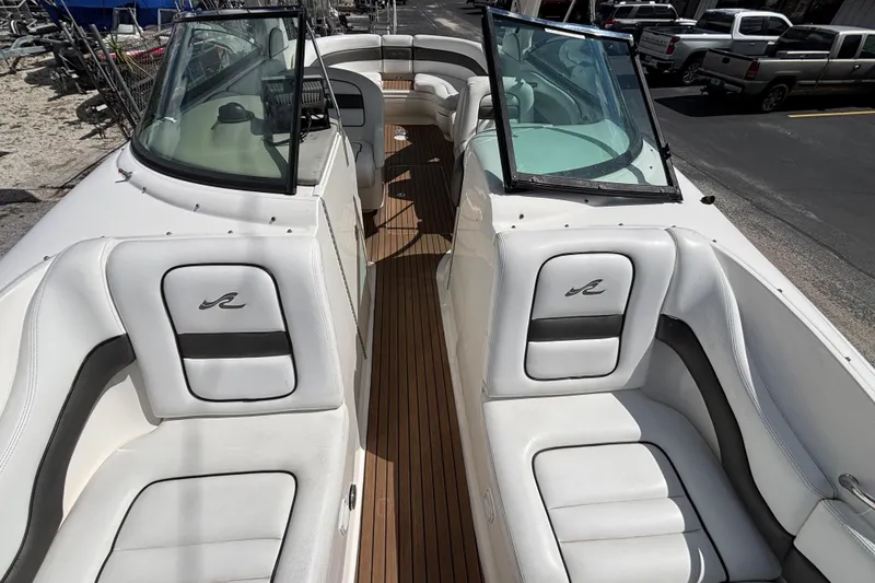 Slide: The Image of 2006 Sea Ray 290 SLX boat interior with white seating and wood flooring. - 44