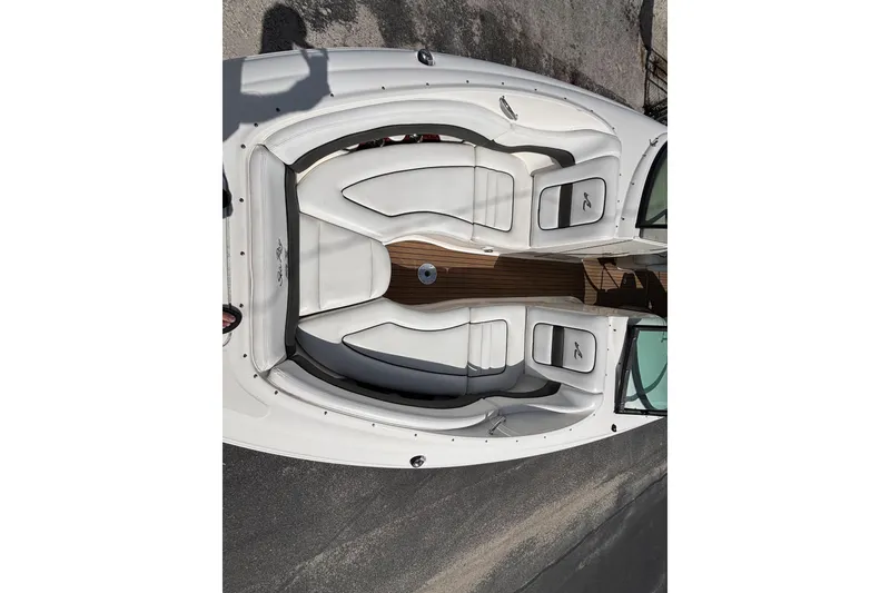 Slide: The Image of 2006 Sea Ray 290 SLX boat interior with white seating and wooden flooring. - 48