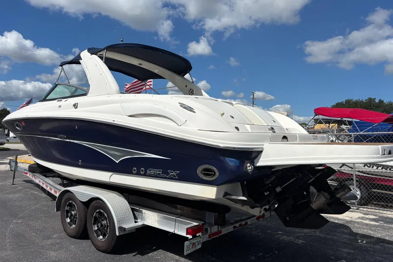 Slide: The Image of 2006 Sea Ray 290 SLX boat on trailer under blue sky. - 5
