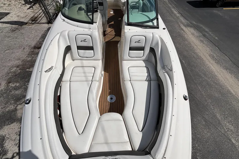 Slide: The Image of 2006 Sea Ray 290 SLX boat with white seating and wooden deck. - 51