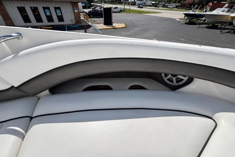 Slide: The Image of 2006 Sea Ray 290 SLX boat interior with white seating and speaker detail. - 52