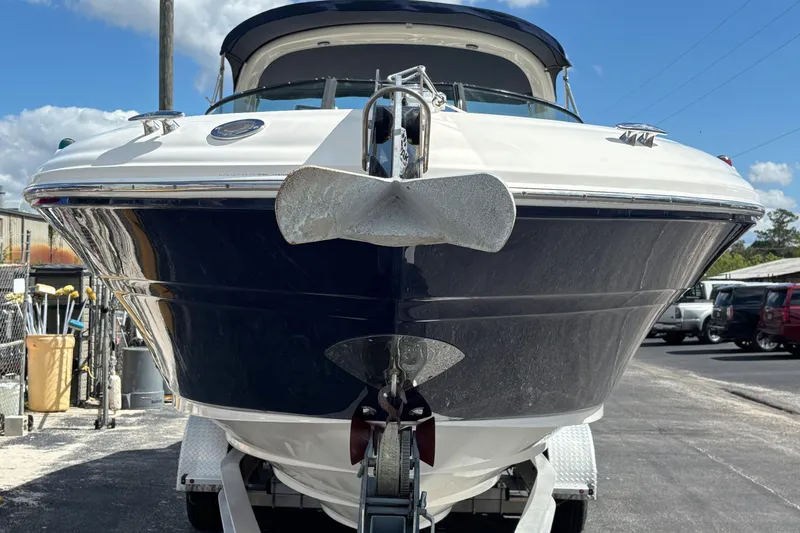 Slide: The Image of 2006 Sea Ray 290 SLX boat on trailer, front view, under clear blue sky. - 8