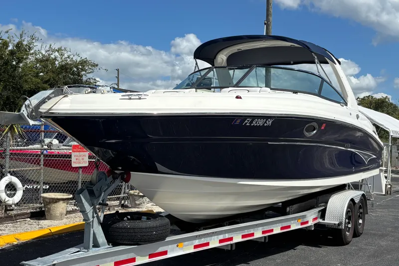 Slide: The Image of 2006 Sea Ray 290 SLX boat on trailer under blue sky. - 9